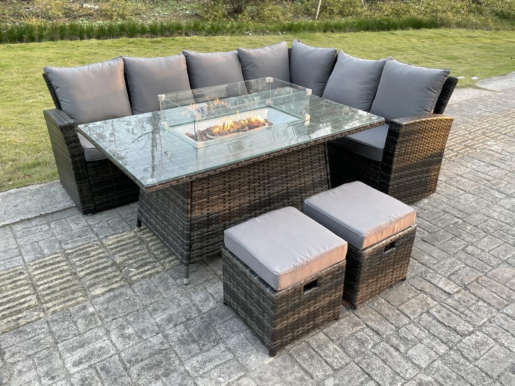 Rattan garden dining furniture with sofa, gas fireplace table, and stools. MéMeubiana dark grey